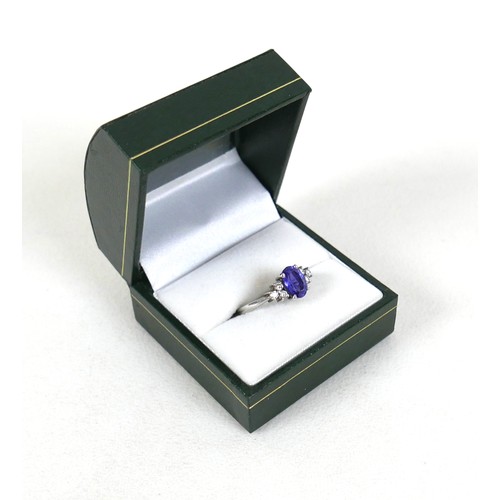 298 - An 18ct white gold Tanzanite and diamond ring, the oval cut tanzanite, by David Tinsley, approximate... 