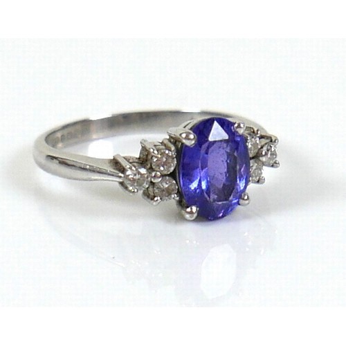 298 - An 18ct white gold Tanzanite and diamond ring, the oval cut tanzanite, by David Tinsley, approximate... 