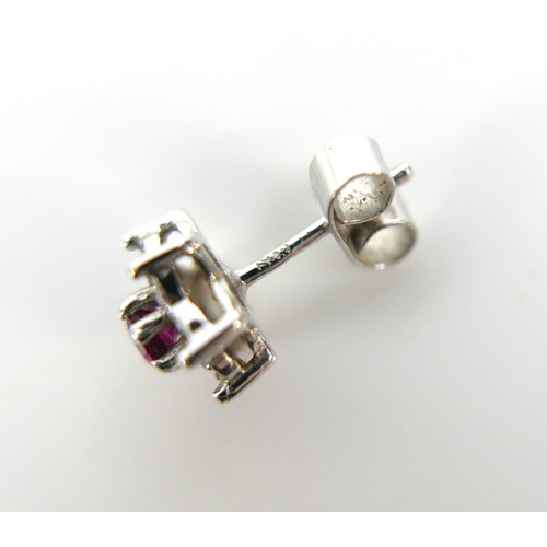 276 - Three pieces of white gold and ruby jewellery, comprising a pair of 18ct white gold ruby and diamond... 