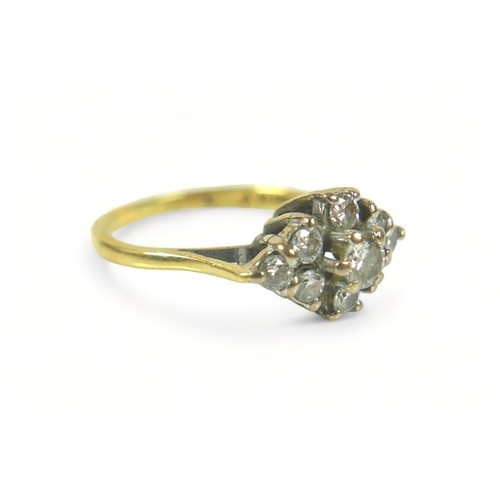 214 - An 18ct gold and diamond ring, set with nine round cut stones in a diamond pattern, central stone 0.... 