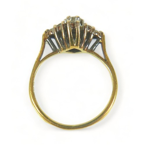 214 - An 18ct gold and diamond ring, set with nine round cut stones in a diamond pattern, central stone 0.... 