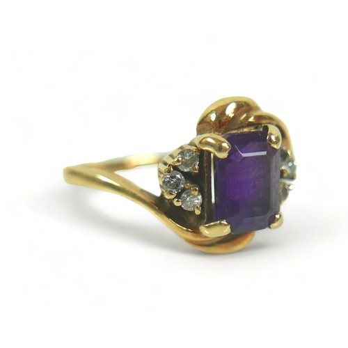 175 - A yellow metal dress ring, set with a rectangular faceted cut purple stone, 7 by 5 by 3mm, flanked b... 