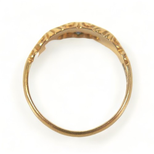 300 - An 18ct yellow gold ring, set with three blue sapphires, central 2.5mm, and two small diamonds withi... 