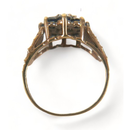 274 - A 9ct gold ring, set with a flowerhead of dark bue sapphires around a single small diamond, with tex... 