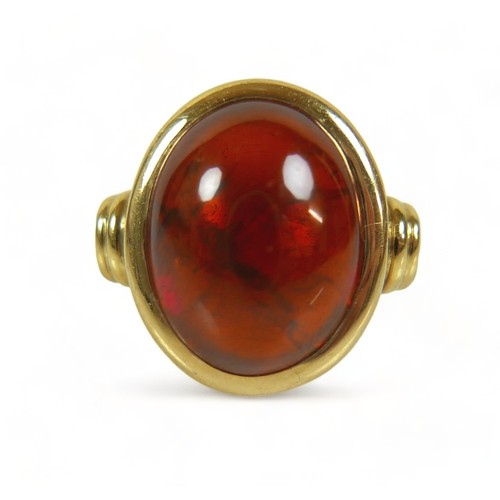 303 - An 18ct yellow gold amber ring size Q, weight 14.3 grams, head size 18mm by 15mm.