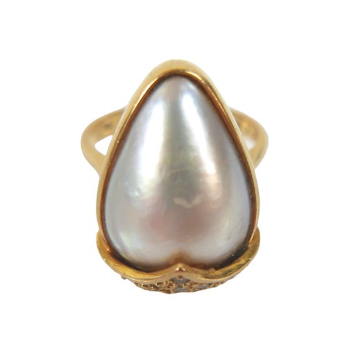 318 - An 18ct gold ring set with large pear-shaped pearl, approximately 12 by 15mm, sixteen small diamonds... 