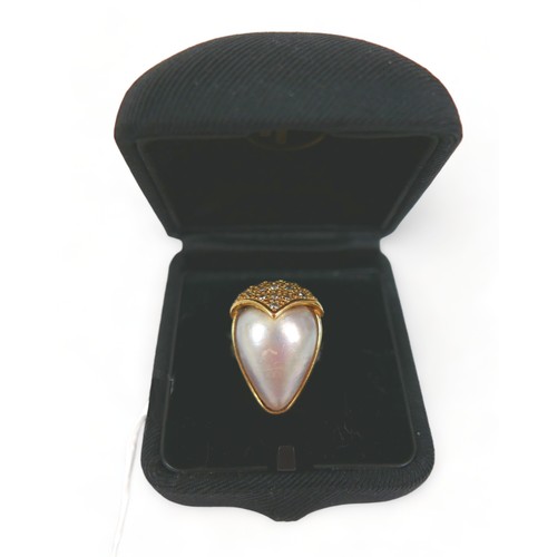 318 - An 18ct gold ring set with large pear-shaped pearl, approximately 12 by 15mm, sixteen small diamonds... 