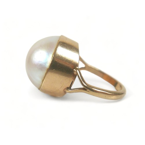 272 - A 9ct gold ring set with a large cabochon pearl, approximately 15 mm diameter, size K, 6.9g.