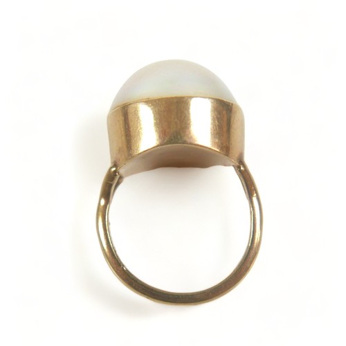 272 - A 9ct gold ring set with a large cabochon pearl, approximately 15 mm diameter, size K, 6.9g.