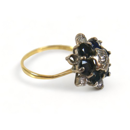 302 - A 18ct diamond and sapphire flowerhead ring, (missing one diamond a/f), with six brilliant-cut diamo... 