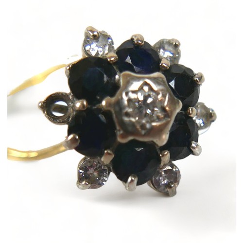 302 - A 18ct diamond and sapphire flowerhead ring, (missing one diamond a/f), with six brilliant-cut diamo... 