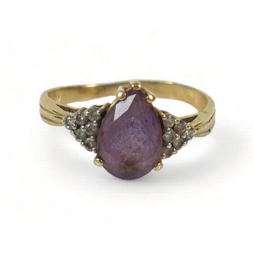 273 - A 14ct gold amethyst and diamond ring, the pear shaped central stone,  flanked by six small white di... 