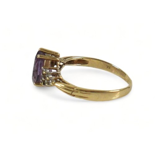 273 - A 14ct gold amethyst and diamond ring, the pear shaped central stone,  flanked by six small white di... 