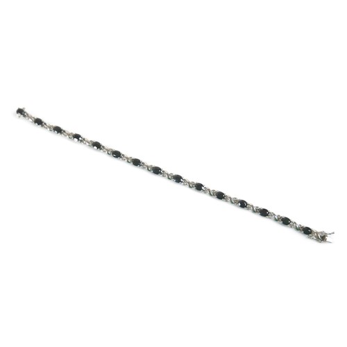 230 - A 9ct white gold diamond and sapphire bracelet, 18cm long, weight 9.1 grams.