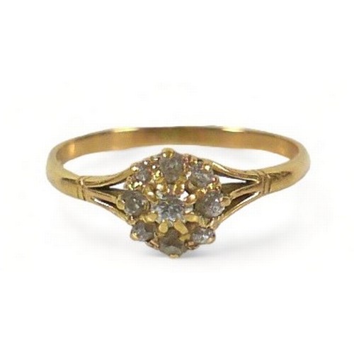 233 - An 18ct gold diamond daisy ring, the largest central round cut stone approximately 3mm diameter, sur... 