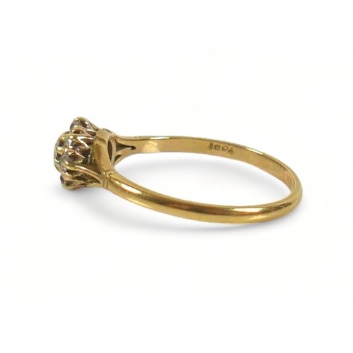 233 - An 18ct gold diamond daisy ring, the largest central round cut stone approximately 3mm diameter, sur... 