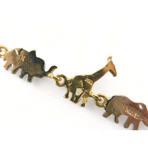 263 - An 18ct tri-colour gold bracelet, formed with five jungle animal figures, lion, rhinoceros, giraffe,... 