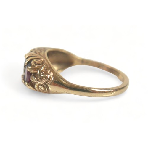 174 - A 9ct gold dress ring, set with three oval cut garnets, largest 6.5 by 4.5mm, size N, 3.4g.