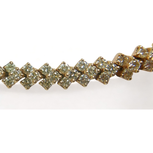 350 - A diamond bracelet on gold mounts set with 105 bright cut diamonds set in chevrons of three stones, ... 