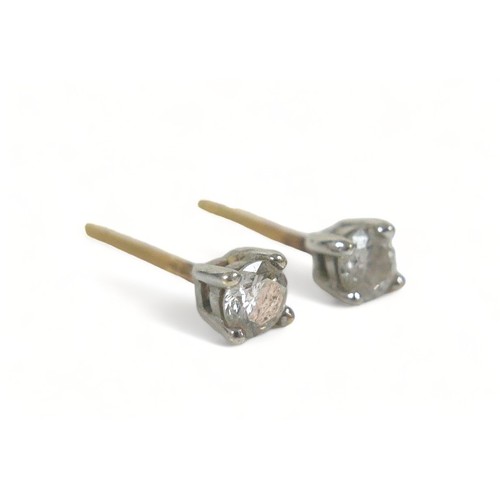 229 - A pair of diamond stud earrings, each approx. 0.1ct, on gold mounts, a/f missing scrolls.