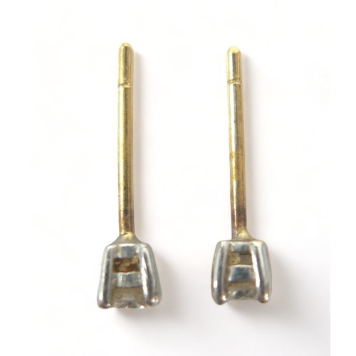 229 - A pair of diamond stud earrings, each approx. 0.1ct, on gold mounts, a/f missing scrolls.