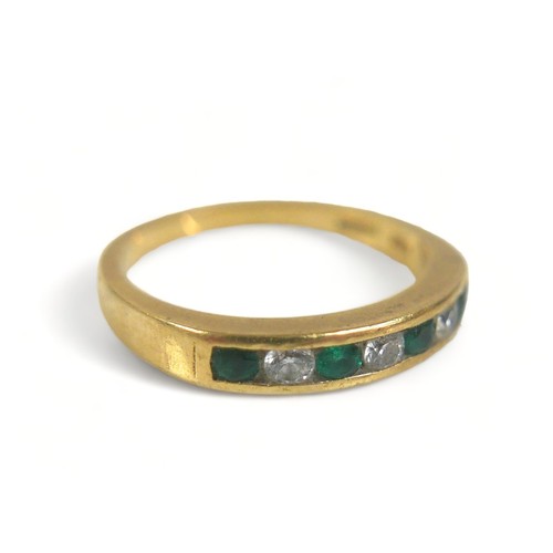 292 - A seven-stone emerald and diamond ring, comprising three diamonds and four emeralds on 750 / 18ct go... 