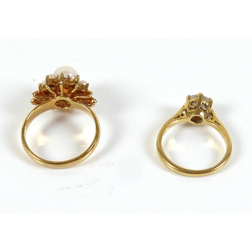 294 - Two gold rings, one marked 585 / 14k set with large pearl and ring of smaller pearls and leaf should... 