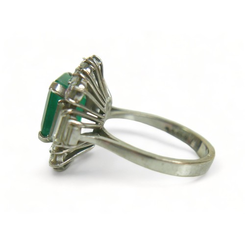 355 - An 18ct white gold emerald and diamond ring, the central square faceted cut emerald approximately 9.... 