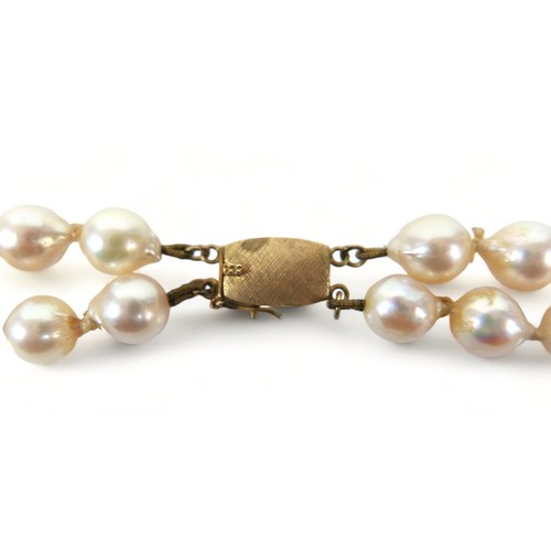 182 - A double string of pearls with a 14ct yellow gold clasp, 47cm long, average size of pearls 7mm.