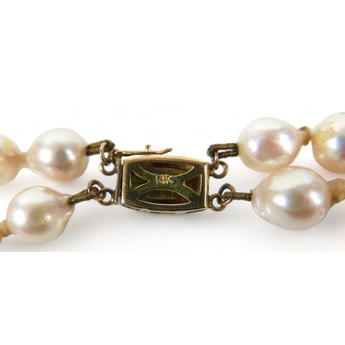 182 - A double string of pearls with a 14ct yellow gold clasp, 47cm long, average size of pearls 7mm.