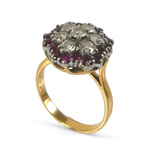 325 - An 18ct diamond and ruby cluster ring, with seven round cut diamonds to its centre, each stone appro... 