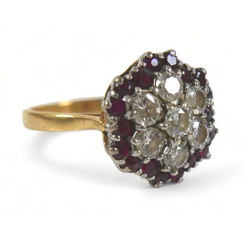 325 - An 18ct diamond and ruby cluster ring, with seven round cut diamonds to its centre, each stone appro... 