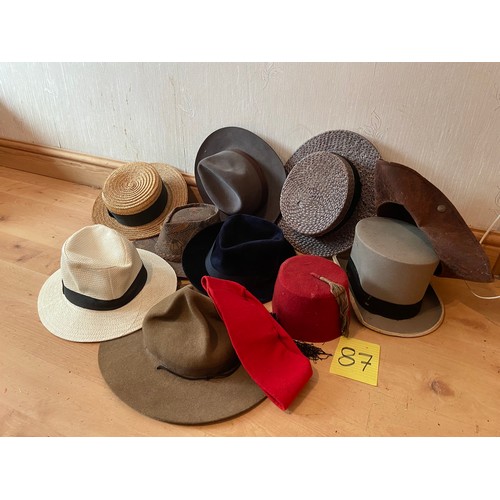 87 - Qty of hats including fez, tricorn, trilby, straw hats and Canadian hat