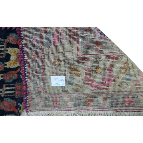 608 - A Hamadan rug, on dark navy ground with repeat pattern to central panel, with large Caucasian border... 