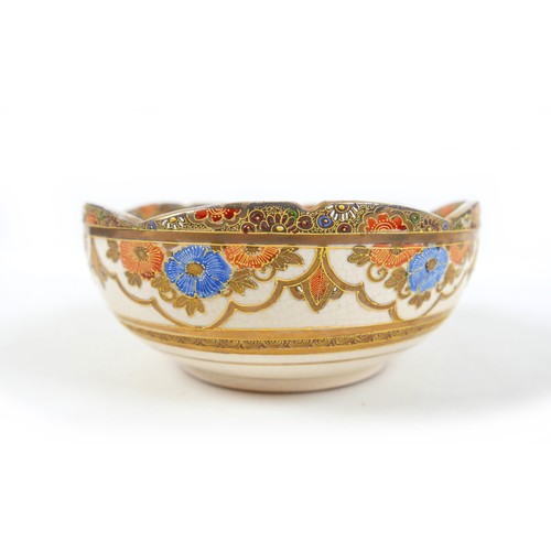 13 - A Japanese Satsuma ware bowl, hand painted with two ladies in a garden, with piped detail and gilt f... 