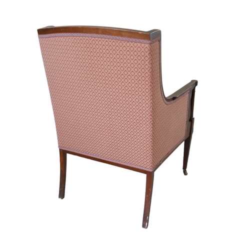 655 - An Edwardian mahogany armchair, upholstered in a pink diamond patterned fabric, raised on tapering s... 