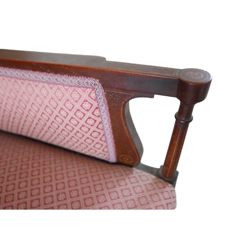 655 - An Edwardian mahogany armchair, upholstered in a pink diamond patterned fabric, raised on tapering s... 