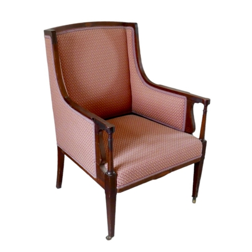 655 - An Edwardian mahogany armchair, upholstered in a pink diamond patterned fabric, raised on tapering s... 