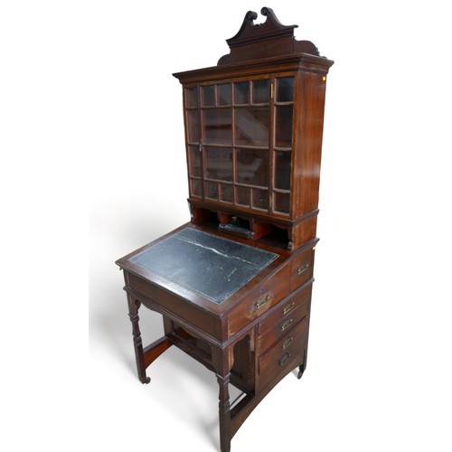 634 - An early 1900s mahogany davenport bookcase with a glazed bookcase top above a leather inset slope an... 