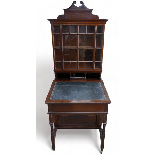 634 - An early 1900s mahogany davenport bookcase with a glazed bookcase top above a leather inset slope an... 