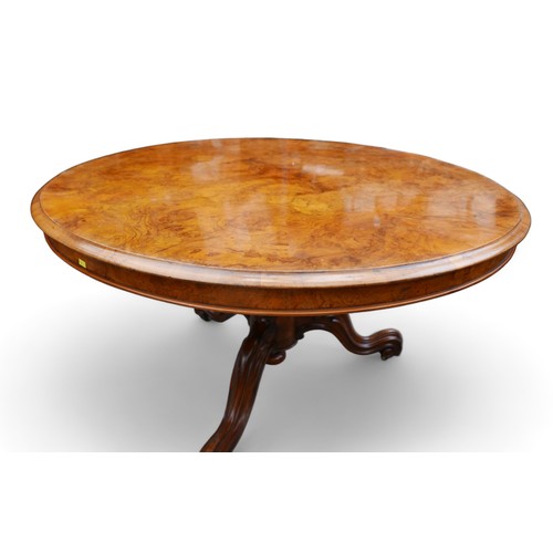 610 - A Victorian Burr walnut breakfast table, with tilt top and raised on three cabriole scroll feet, 121... 