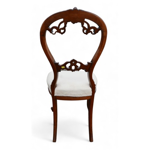 611 - A set of six Victorian dining chairs, the balloon back and middle rail carved with foliage scrolls, ... 