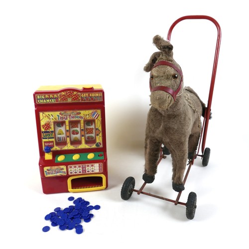 188 - A group of toys, comprising an International Aircraft Co Ltd. push along donkey, 53cm high, a plasti... 