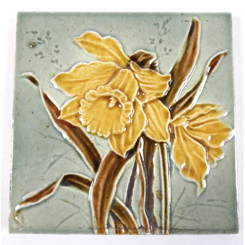 75 - A set of four Art Nouveau tiles, by Henry Abraham Ollivant, each decorated with a daffodil, 15.5 by ... 