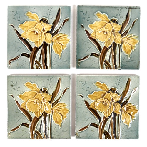 75 - A set of four Art Nouveau tiles, by Henry Abraham Ollivant, each decorated with a daffodil, 15.5 by ... 