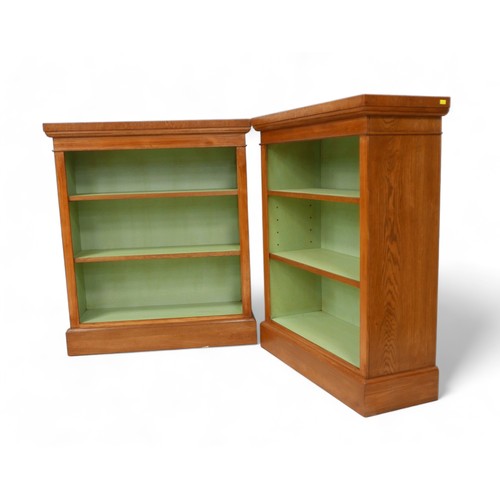 643 - A pair new of burr oak open bookcases with painted interior and two adjustable shelves, 80cm by 30cm... 