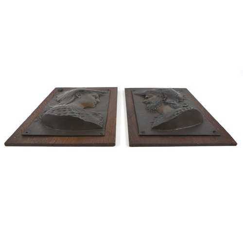 139 - A pair of bronzed classical Greek plaques on oak boards 25cm by 35cm.