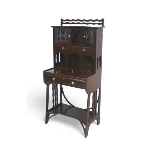 639 - A late 19th century arts and crafts mahogany bonheur de jour writing desk attributed to Liberty & Co... 