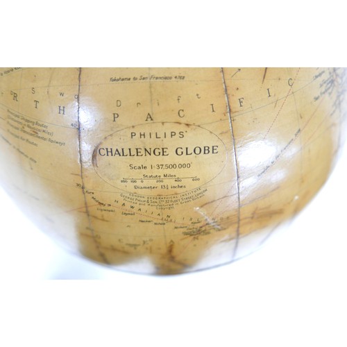 635 - A Phillips 12 inch terrestrial library globe on an ebonies tripod stand, 34 by 90 cm tall.