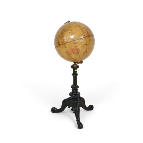 635 - A Phillips 12 inch terrestrial library globe on an ebonies tripod stand, 34 by 90 cm tall.